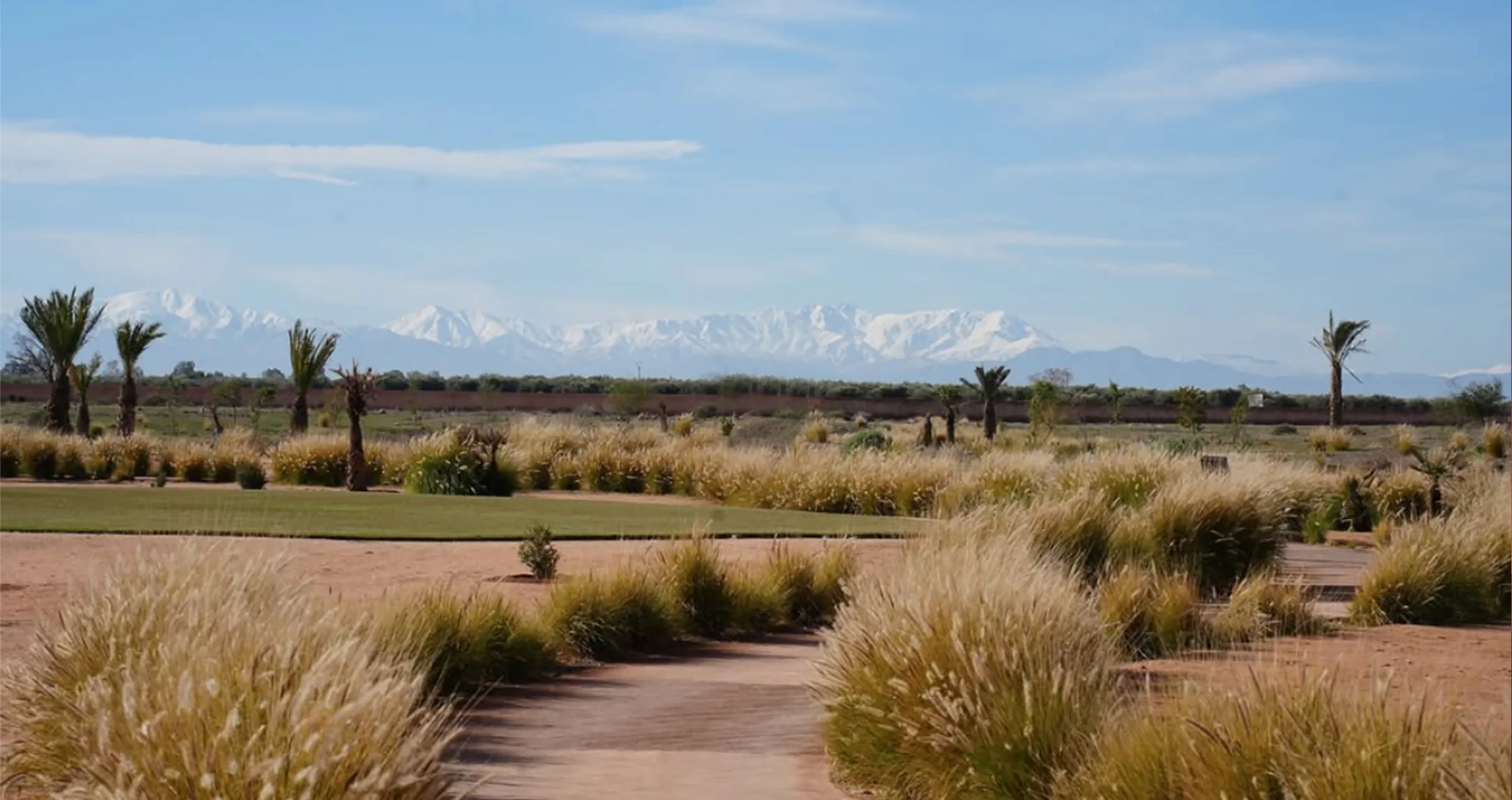 Parcours de golf à Marrakech avec l’Atlas enneigé en arrière-plan